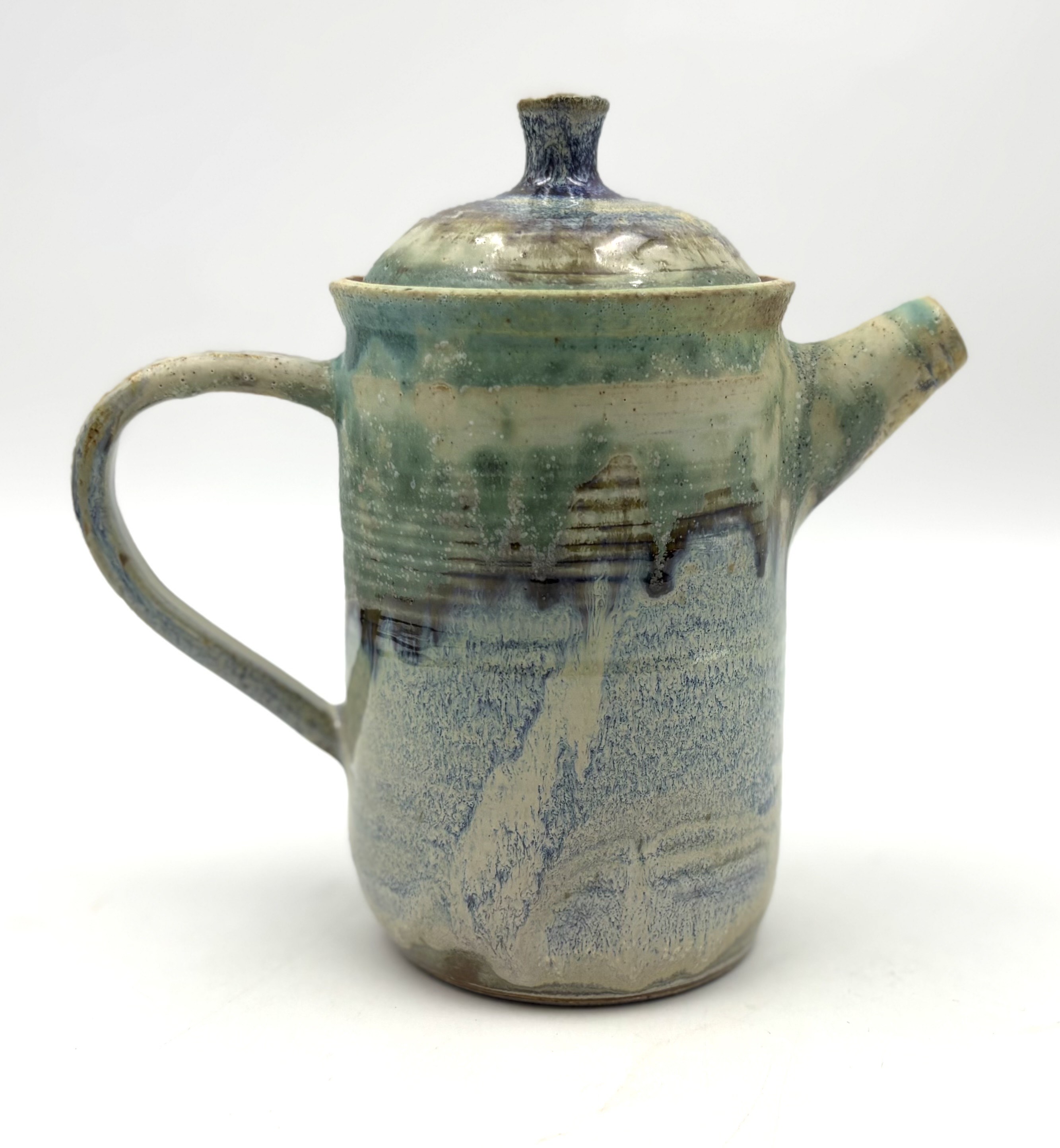 Pouring pot with green, blue and cream glazed surface