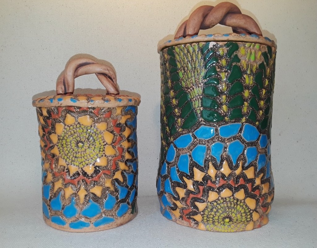 Colorful lidded jars with textured, handpainted decoration