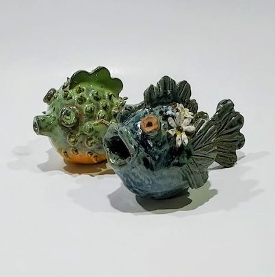 Two sculpted fish with blue and green glazes