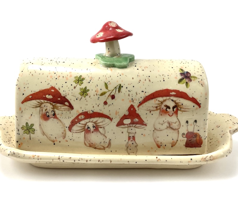 Light yellow speckled butterdish decorated with mushrooms