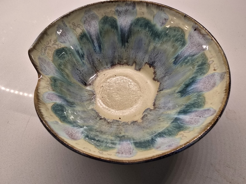 Yellow gold bowl with green and purple glaze runs