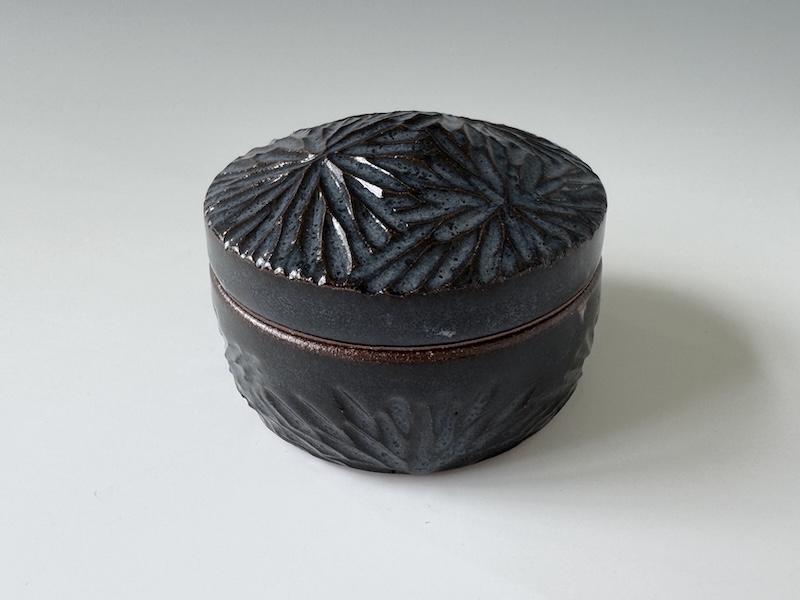 Black Covered Jar with Carving