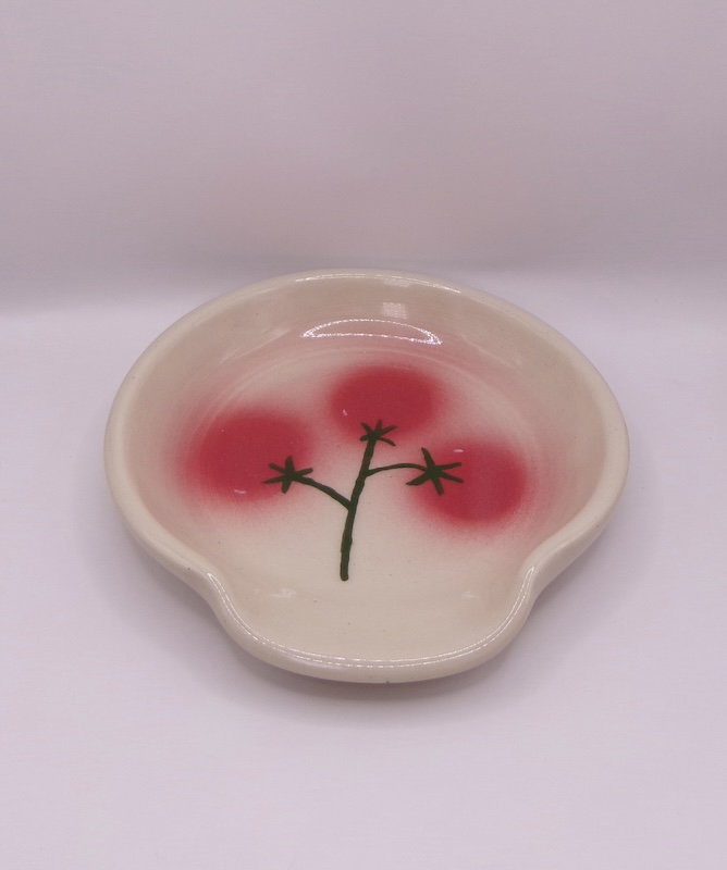 Circular spoonrest with fuzzy cherry tomato motif