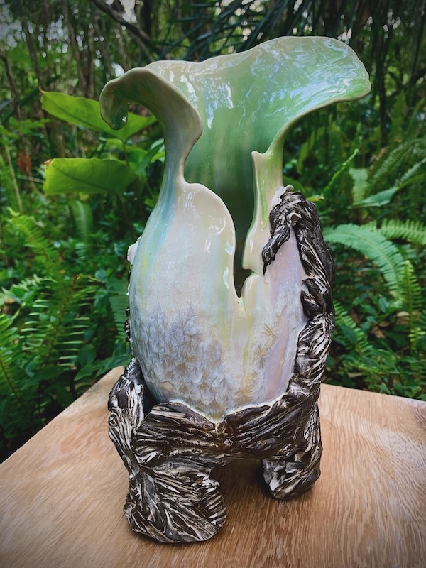 Organic vase with a treelike footed base, bulbous split form, and mint green interior