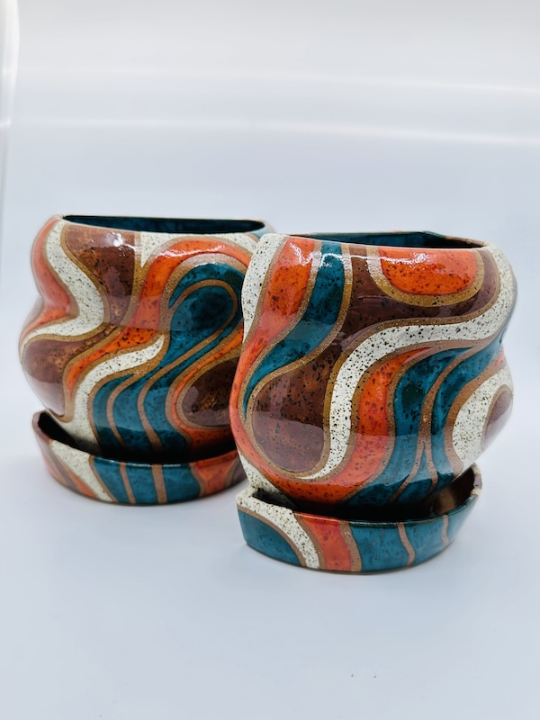 Orange, teal and maroon flower pots with modern organic curved design