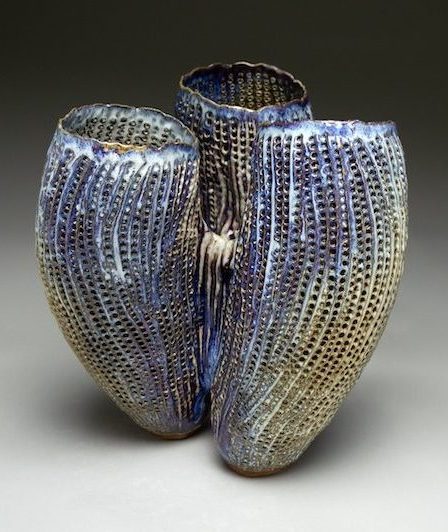 Coral-like perforated vessel with blue and tan glazes